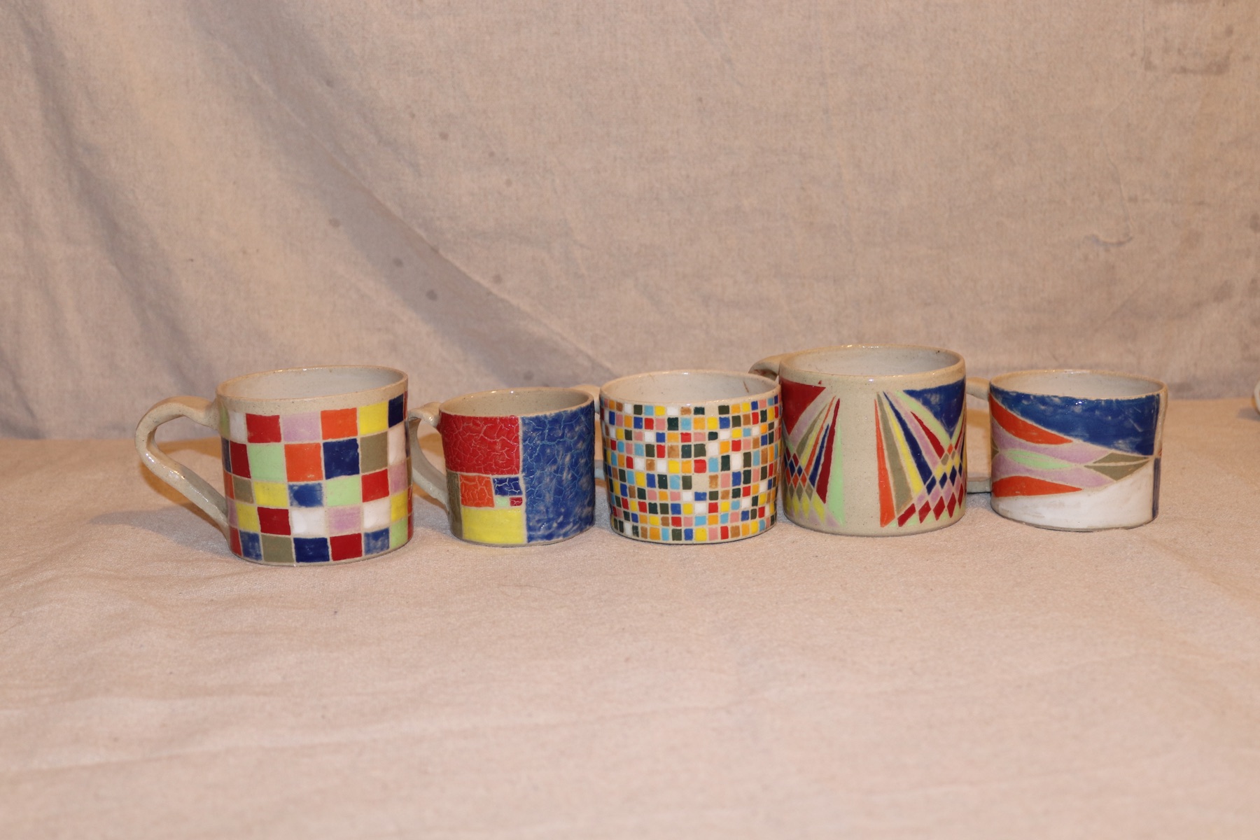 A group of handmade cups with varied surfaces
