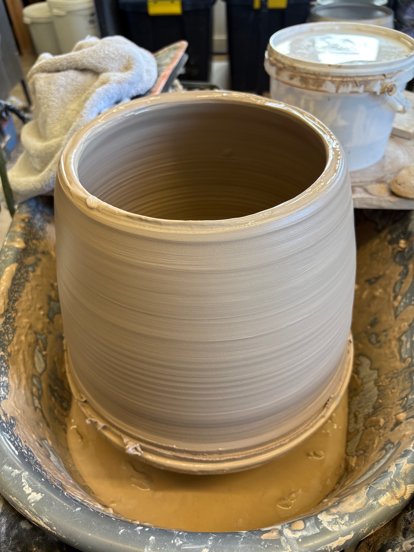 Closed-end ceramic drum being worked on the wheel