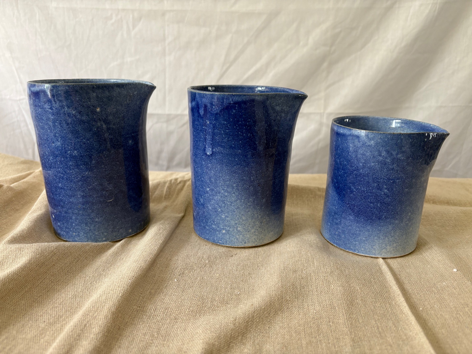 Set of blue handmade ceramic pouring jugs