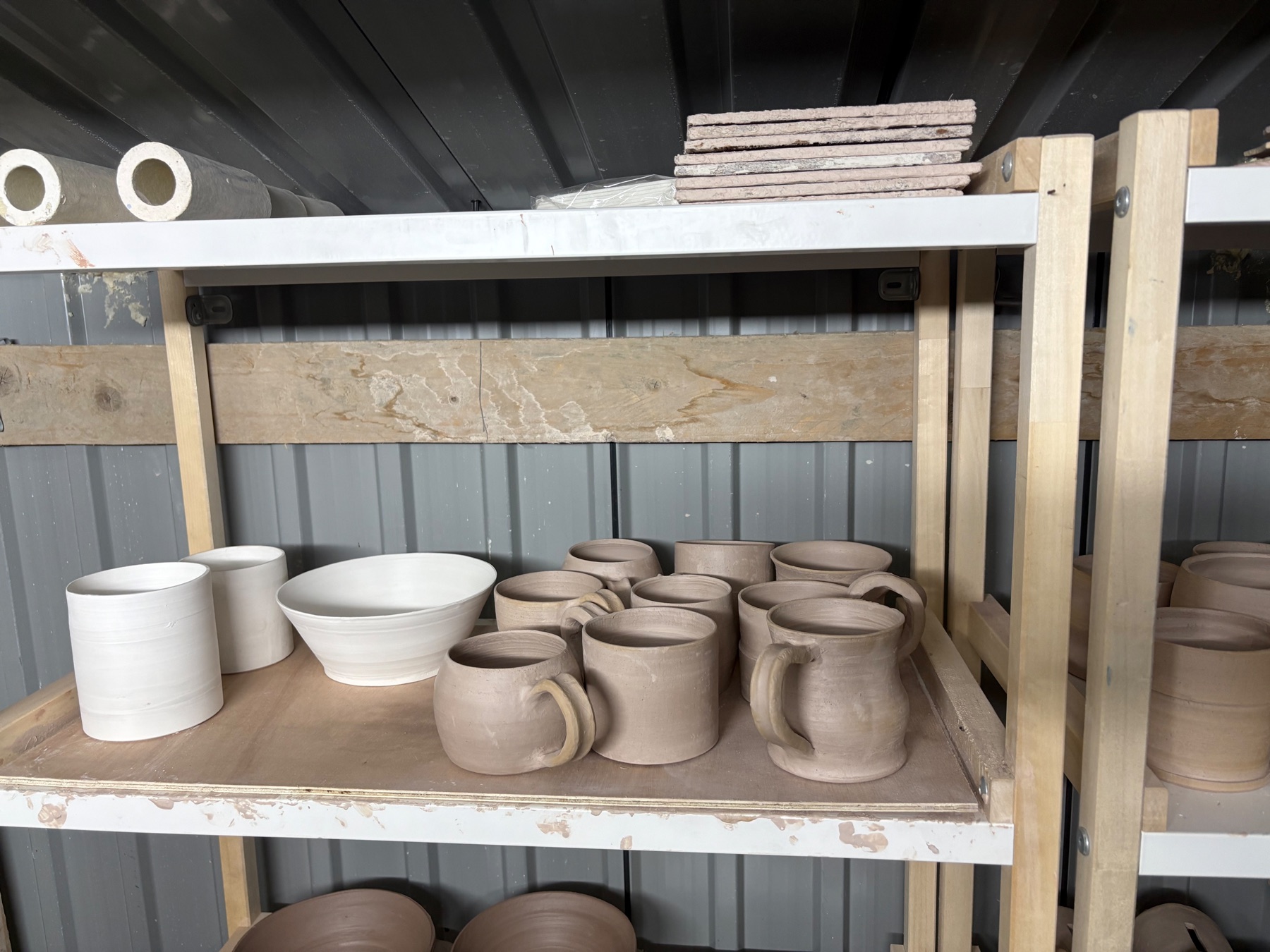 Bisque-fired pottery pieces in the studio